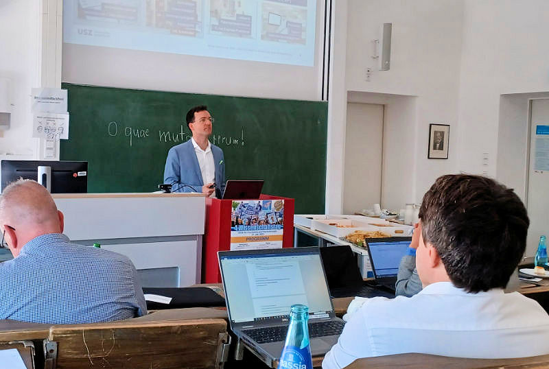 Dr. Peter Kauf hält vor Teilnehmern einen Vortrag